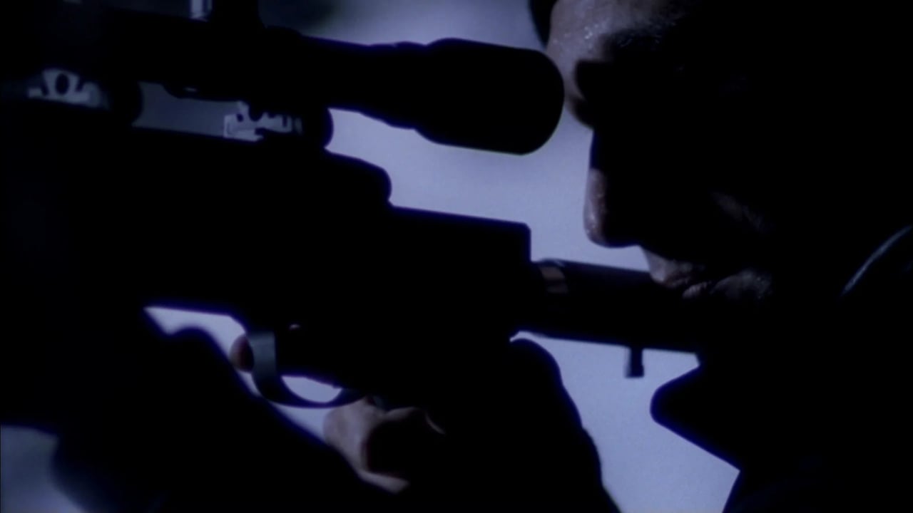 Close-up of a shadowed figure in the foreground facing another person in blue-tinted, cinematic lighting.