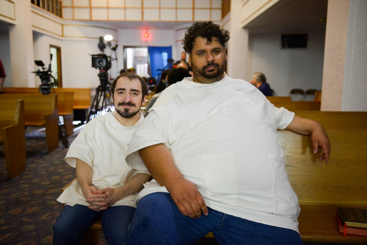 Candid set portrait of two people in a film venue