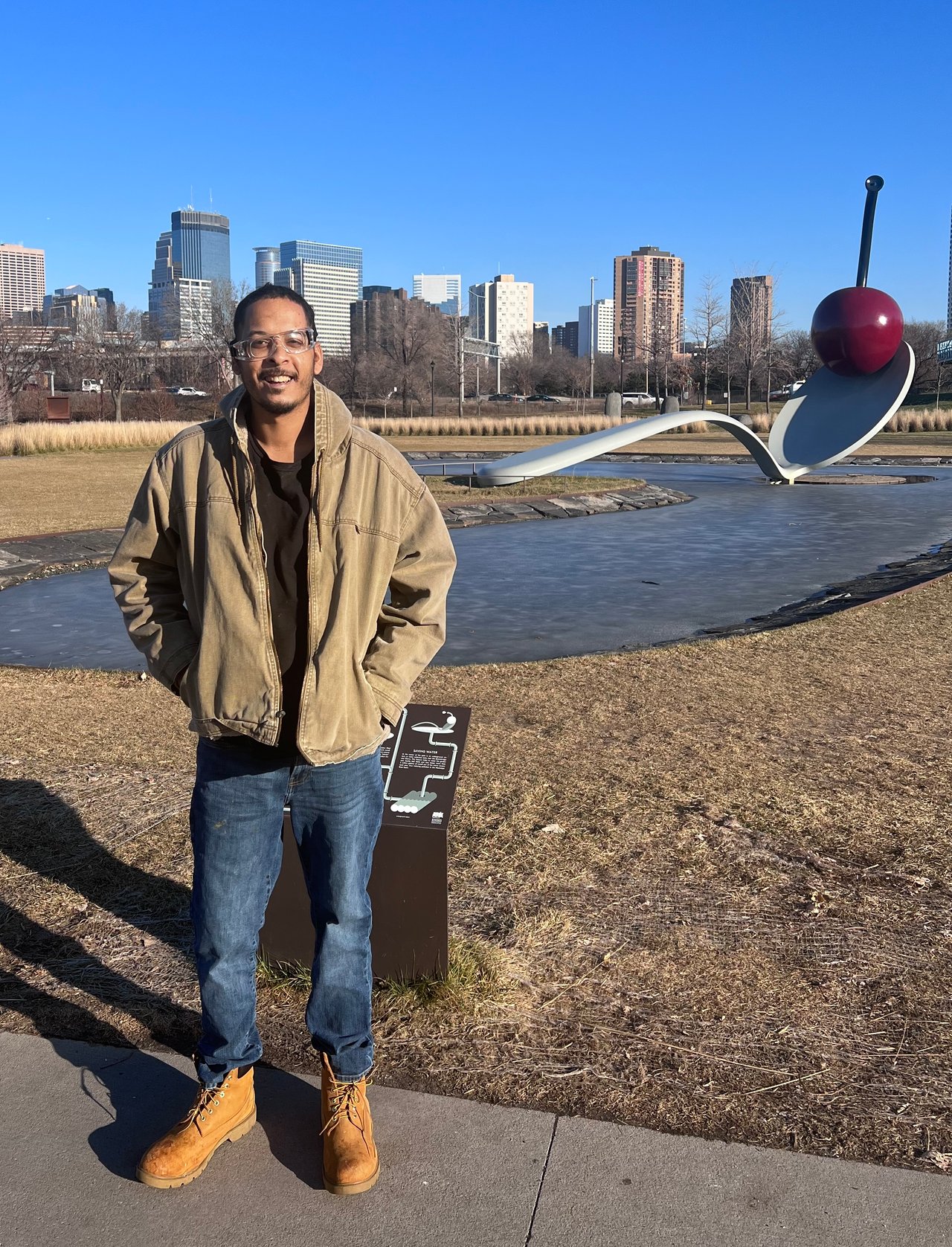 Person at outdoor water feature with city skyline