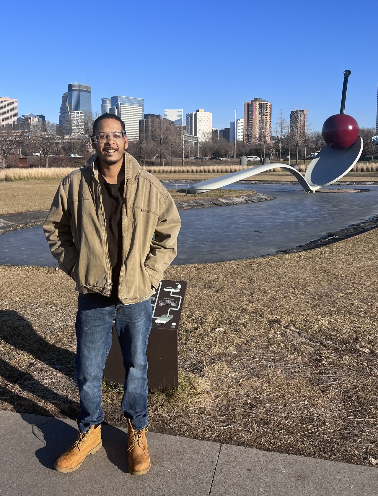 Person at outdoor water feature with city skyline