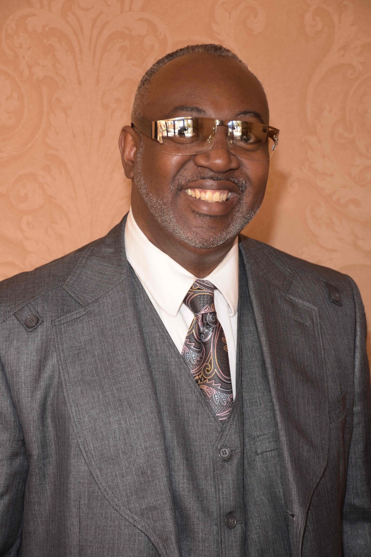 Smiling man in suit with reflective glasses